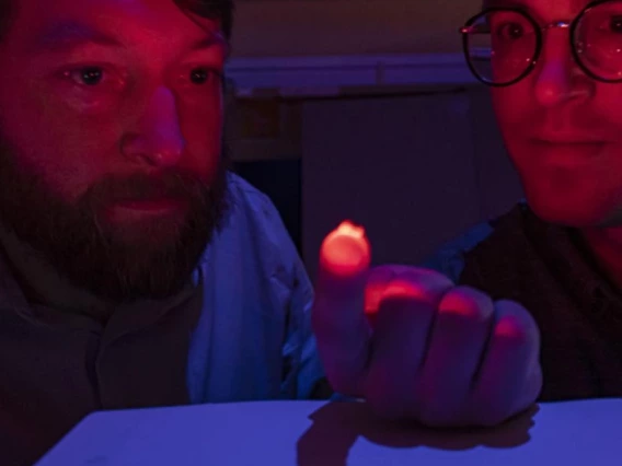 Philipp Gutruf illuminates a neural sensor in a lab at the University of Arizona