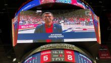 Vignesh Subbian pictured on a large screen at Arizona Stadium. The lower third of the screen reads "Arizona Champions."