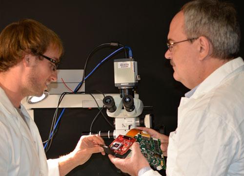 Doctoral student Jeffrey Watson, left, and associate professor Marek Romanowski assemble parts for the prototype microscopy device.