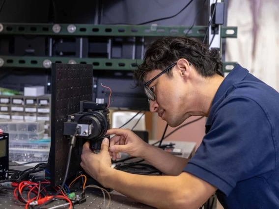 Dongkyun Kang working on a medical device in a lab