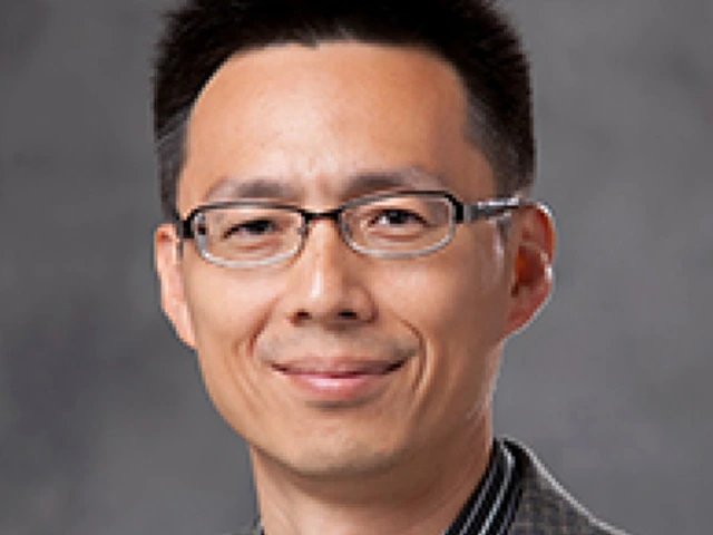 person with short dark hair, wearing glasses and plaid suit