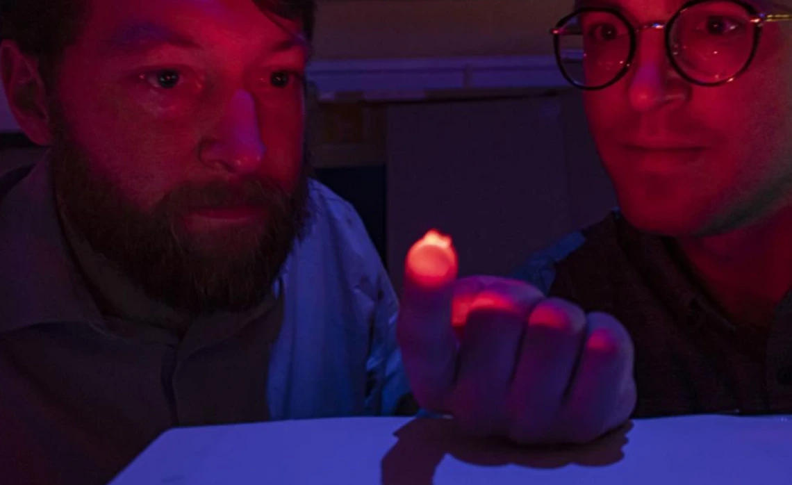 Philipp Gutruf illuminates a neural sensor in a lab at the University of Arizona