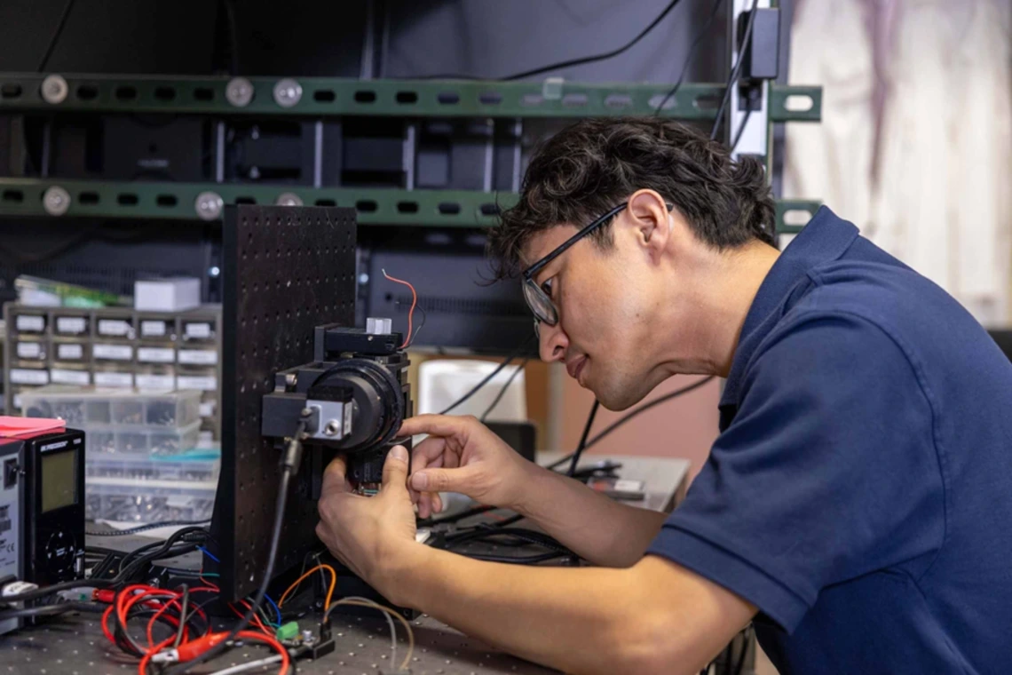 Dongkyun Kang working on a medical device in a lab