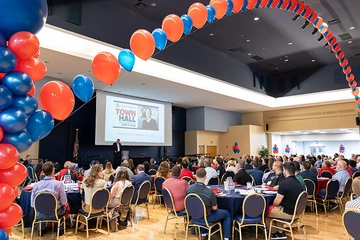 homecoming attendees in grand ballroom, decorated with balloons
