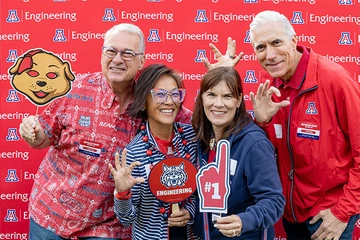 four  people, smiling with Univ of AZ SWAG