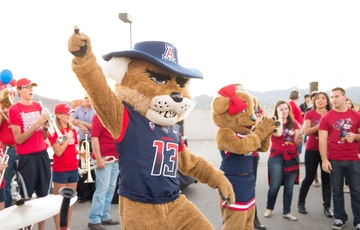 Wilbur and Wilma mascots with Univ of AZ marching band