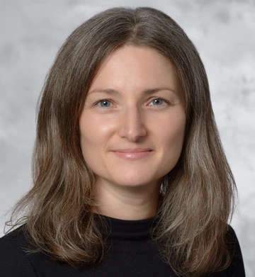 headshot of person with long hair, wearing black shirt