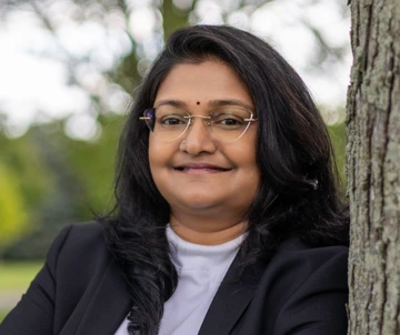 person with long, dark hair, wearing black jacket